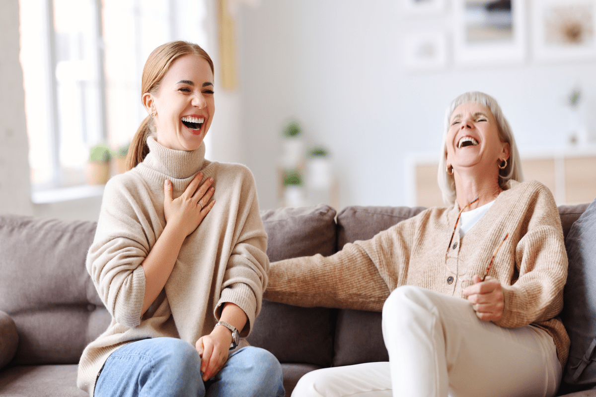 Adult and aged women laughing out loud at joke